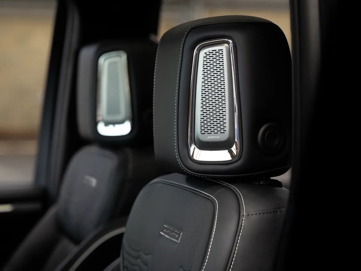 A Close-up View of the GMC Sierra 1500 AT4X Black Leather Seat Headrest with a Speaker Grille