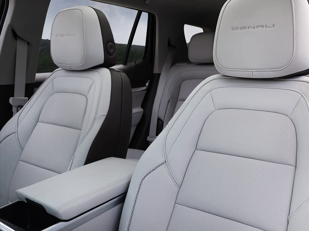 An Interior View of a GMC Denali SUV Showing the Front Gray Leather Seats with Denali Embossed on the Headrests