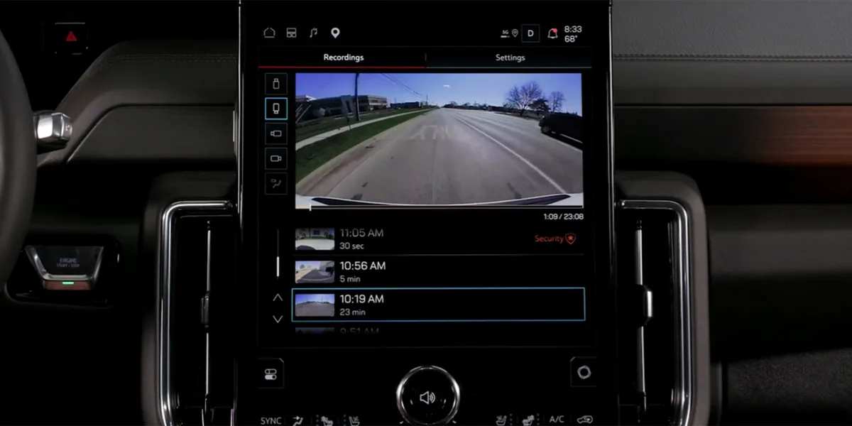 Central Infotainment Screen of a GMC Yukon XL Displaying Security Camera Recordings of a Parking Lot